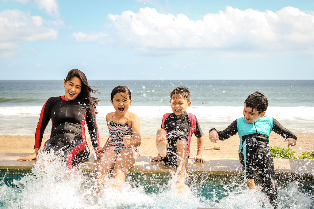 family splashing at resort