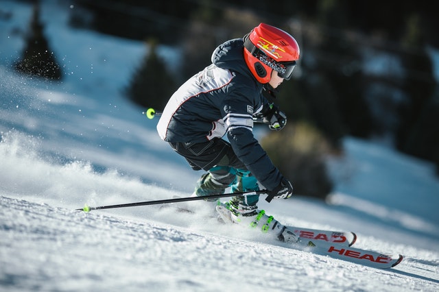 A child skiing on a mountain slope.