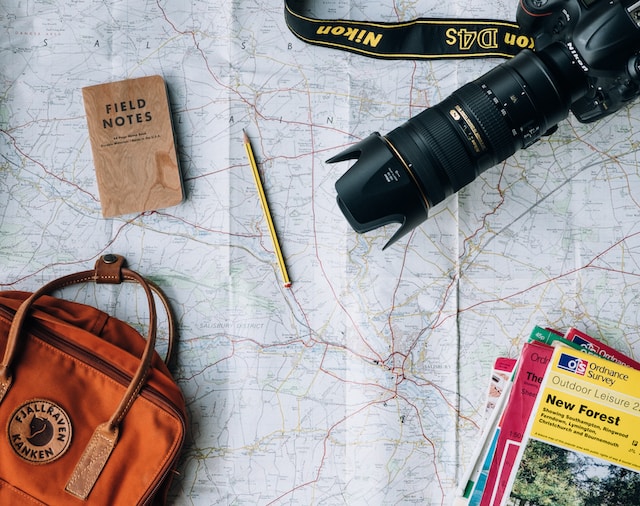 travel map with a camera, road map, and notebook