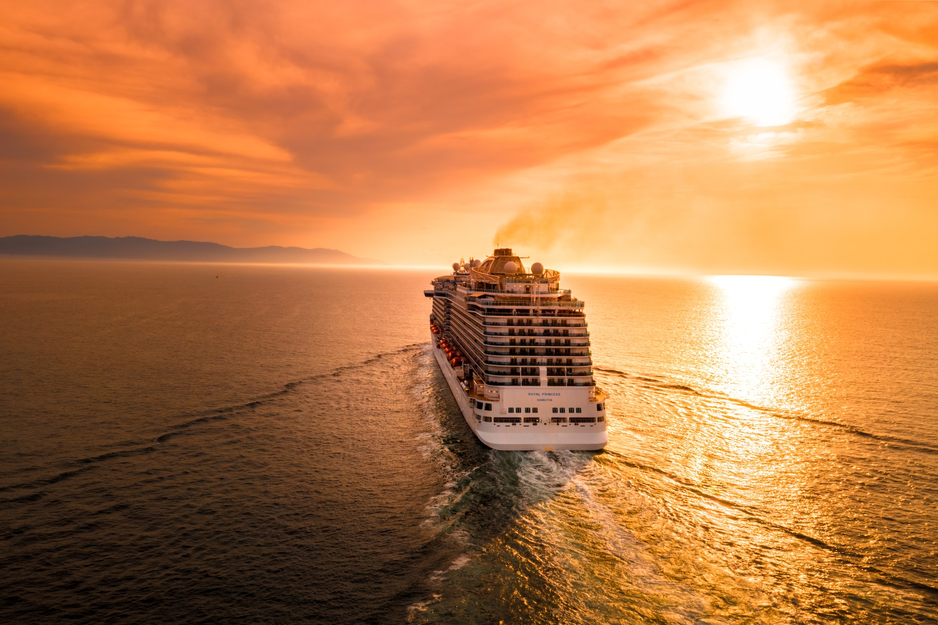 A cruiser sailing into the sunset.