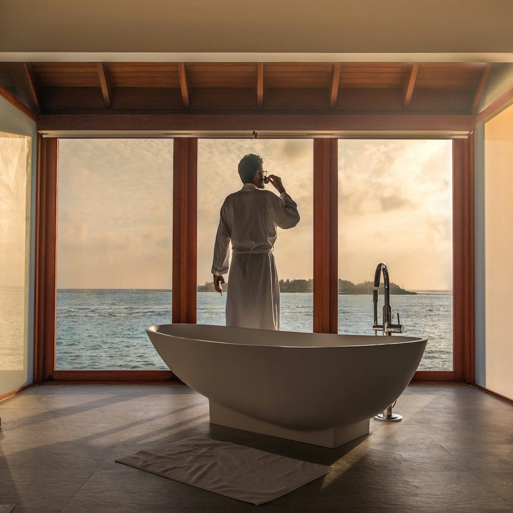 Man watching sunset from luxury hotel