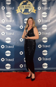 Travel Brilliant Founder, Denise Ambrusko-Maida accepts the award for Leadership in Family and Multi-Generational Travel