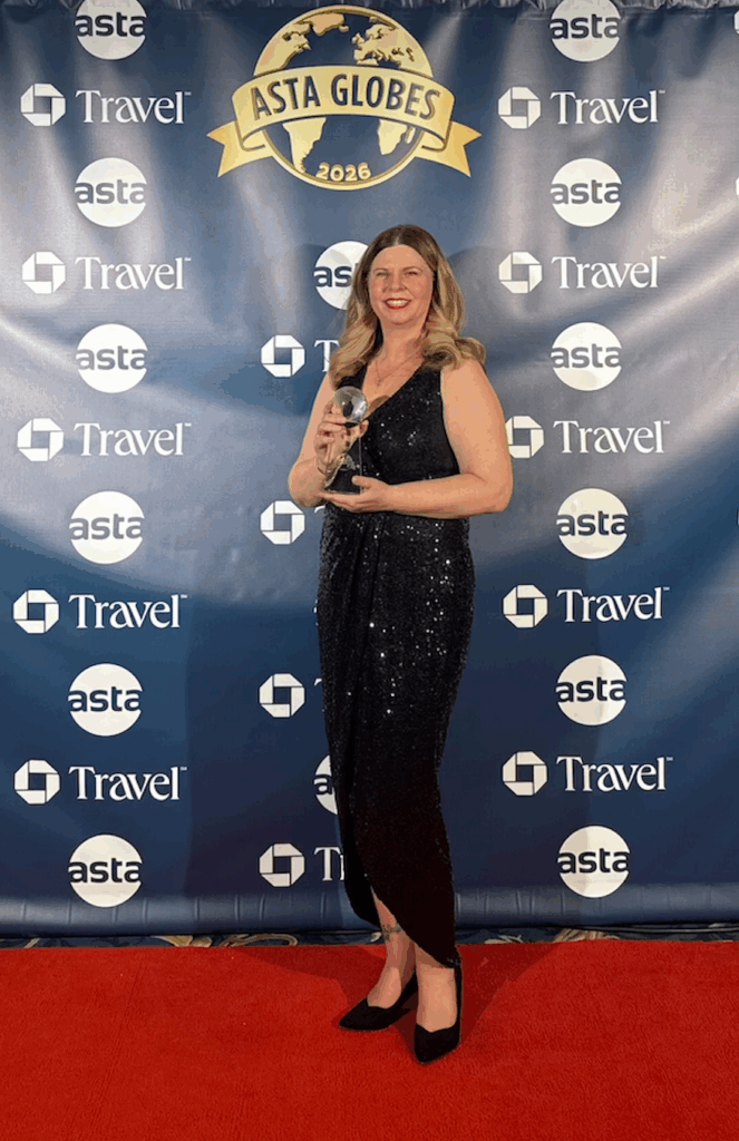 Travel Brilliant Founder, Denise Ambrusko-Maida accepts the award for Leadership in Family and Multi-Generational Travel