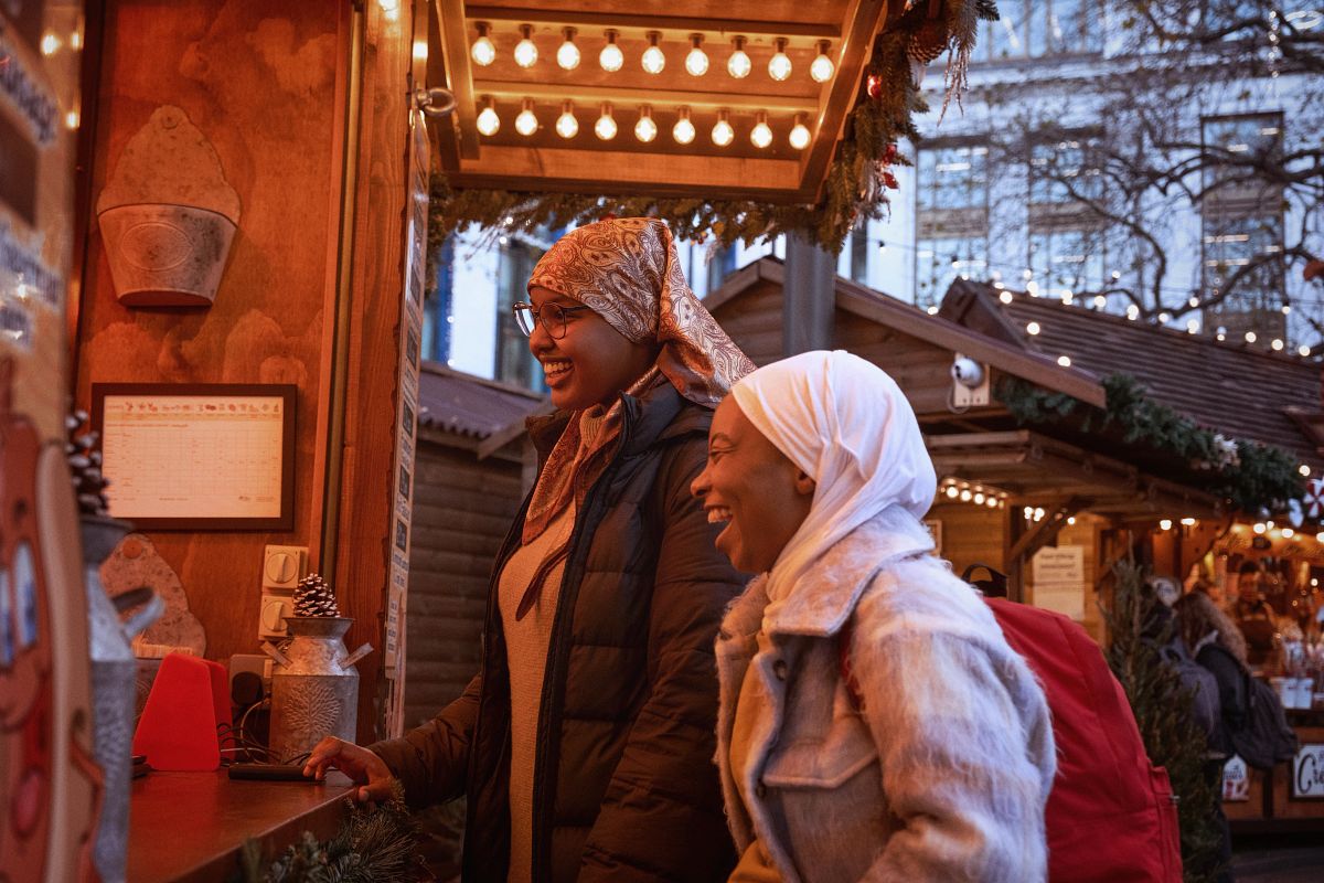Travelers exploring a European Christmas market during a river cruise