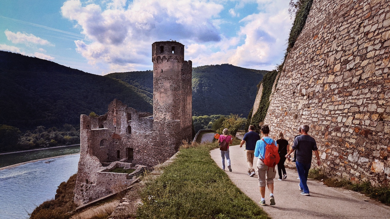 River cruise travelers exploring a historic castle along the Rhine